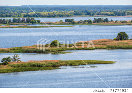 Dnipro river blossoming shores summer landscape, Kaniv water Reservoir, Kyiv Region, Ukraine. Dnipro river blossoming shores summer landscape, Kaniv water Reservoir, Kyiv Region, Ukraine. 73774934