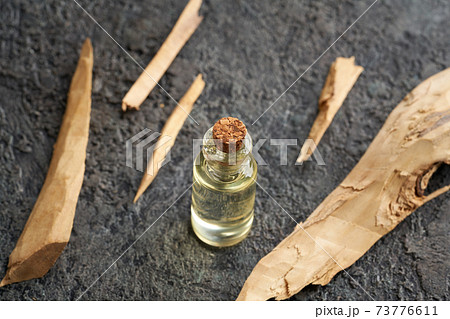 A bottle of essential oil with white sandalwood 73776611
