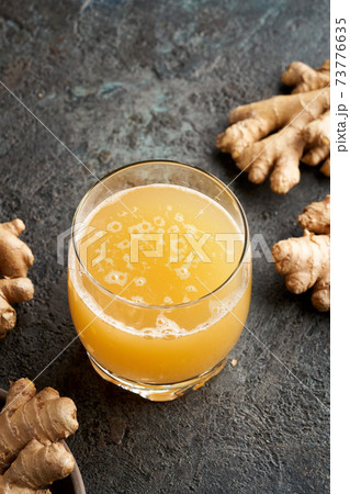 Probiotic drink with ginger in a glass, vertical with copy space 73776635