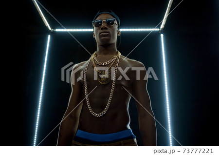Serious rapper in gold chains, bottom view 73777221