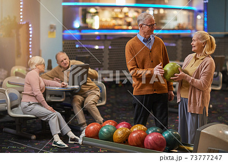 Joyful Senior Couple Playing Bowling Joyful Senior Couple Playing Bowling 73777247