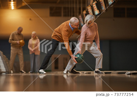 Active Senior Couple Playing Bowling Side View 73777254