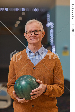 Senior Man Holding Bowling Ball Senior Man Holding Bowling Ball 73777321