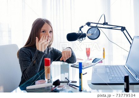 Young blogger in front of camera recording vlog herself talking about with makeup cosmetics for internet social networks at home 73779534
