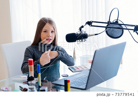 Beautiful young teen blogger or vlogger showcases her cosmetics. Beautiful young teen blogger or vlogger showcases her cosmetics. 73779541