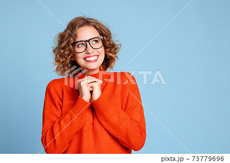 Delighted young female smiling and dreaming Delighted young female smiling and dreaming 73779696