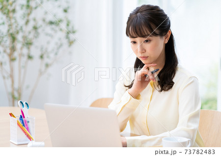 リビングでテレワーク中の女性。 リビングでテレワーク中の女性。 73782483