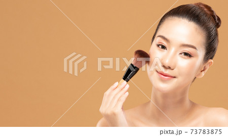 Beauty asian woman hold make up brush and cheerful with make up brush Beauty asian woman hold make up brush and cheerful with make up brush 73783875