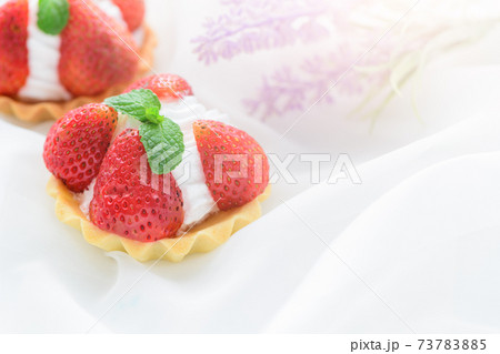 Strawberry Tart with mint leaf on cream cheese on white cloth background, Strawberry Tart with mint leaf on cream cheese on white cloth background, 73783885