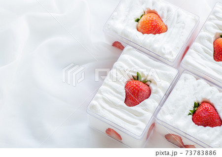 strawberry shortcake in plastic box on with cloth background and copy space, 73783886