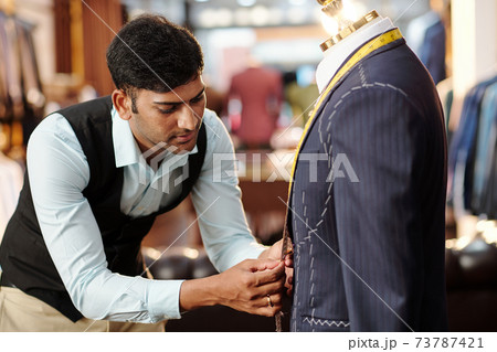 Tailor working on bespoke suit 73787421