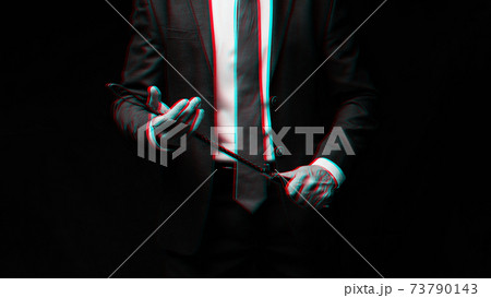 Male dominant businessman in a suit holding a leather whip Flogger for domination 73790143