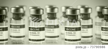 Covid-19 vaccine bottles on a black and white background 73790986