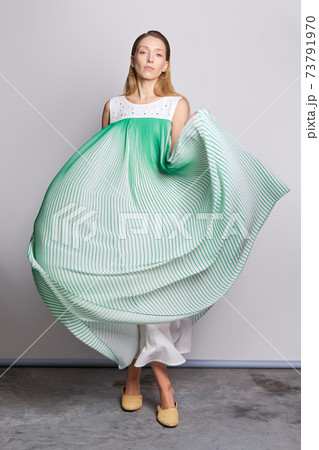 Full length portrait of model waving light airy sundress Full length portrait of model waving light airy sundress 73791970