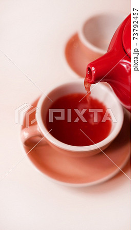 Monochrome image of raspberry or berry tea in cups with a teapot. 73792457