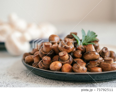 Fried mini champignons on plate, copy space 73792511
