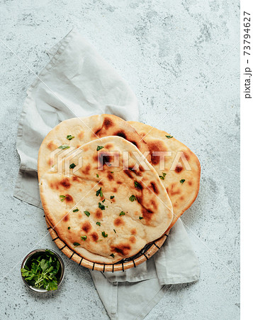 naan flatbreads on gray cement, copyspace vertical naan flatbreads on gray cement, copyspace vertical 73794627