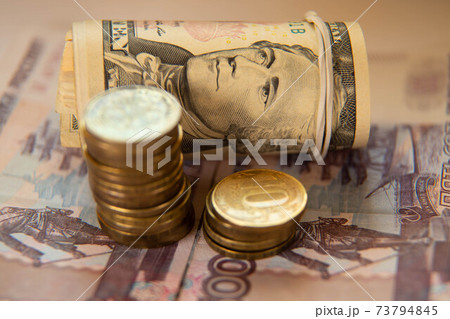 dollars in a tube and ruble bills of 500 and coins of rubles 73794845