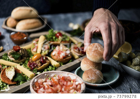 man preparing vegan sandwiches 73799278