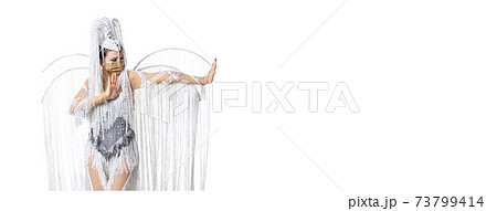 Beautiful young woman in carnival, stylish masquerade costume with feathers dancing on white studio background. Concept of holidays celebration, festive time, fashion 73799414