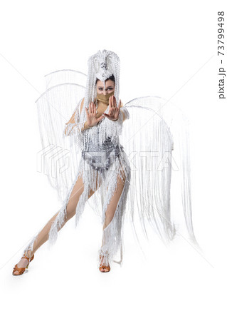 Beautiful young woman in carnival, stylish masquerade costume with feathers dancing on white studio background. Concept of holidays celebration, festive time, fashion 73799498