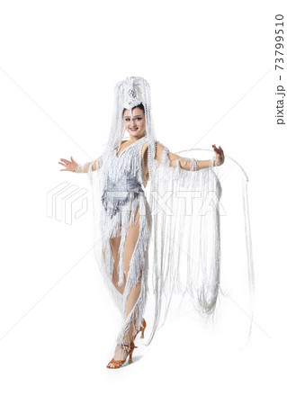 Beautiful young woman in carnival, stylish masquerade costume with feathers dancing on white studio background. Concept of holidays celebration, festive time, fashion Beautiful young woman in carnival, stylish masquerade costume with feathers dancing on white studio background. Concept of holidays celebration, festive time, fashion 73799510