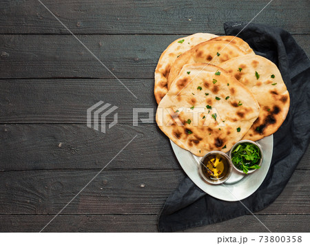 naan flatbreads on dark wood, copy space, top view naan flatbreads on dark wood, copy space, top view 73800358
