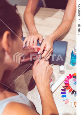 Close up of hands and nails of two woman. Manicure concept. Close up of hands and nails of two woman. Manicure concept. 73800545
