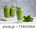 Freshly blended green fruit smoothie in glass. 73803064