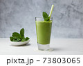 Freshly blended green fruit smoothie in glass. 73803065