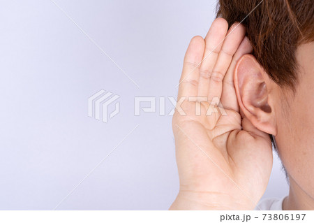 man hearing loss or hard of hearing and cupping his hand behind his ear isolate grey background, Deaf concept. 73806197