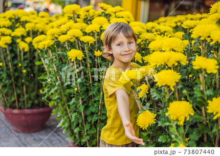 Caucasian tourist boy in Tet holidays. Vietnam Chinese Lunar New Year in springtime Caucasian tourist boy in Tet holidays. Vietnam Chinese Lunar New Year in springtime 73807440