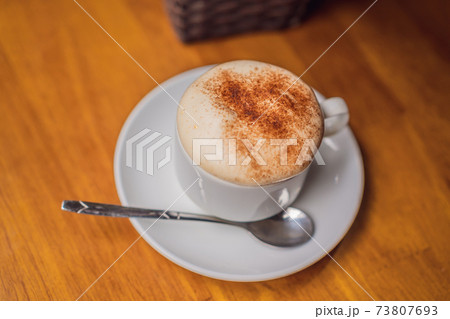 Top view a cup of Giang egg coffee on wood background. Vietnamese coffee in Ha Noi, Vietnam. Eggs are beaten with coffee, hot drink or with ice 73807693