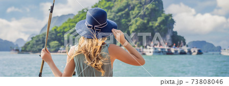BANNER, LONG FORMAT Attractive woman in a dress is traveling by boat in Halong Bay. Vietnam. Travel to Asia, happiness emotion, summer holiday concept. Picturesque sea landscape. Ha Long Bay, Vietnam BANNER, LONG FORMAT Attractive woman in a dress is traveling by boat in Halong Bay. Vietnam. Travel to Asia, happiness emotion, summer holiday concept. Picturesque sea landscape. Ha Long Bay, Vietnam 73808046