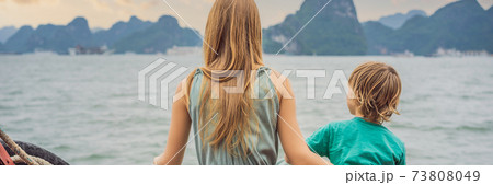 BANNER, LONG FORMAT Mom and son travelers is traveling by boat in Halong Bay. Vietnam. Travel to Asia, happiness emotion, summer holiday concept. Traveling with children concept. After COVID 19 73808049