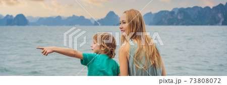 BANNER, LONG FORMAT Mom and son travelers is traveling by boat in Halong Bay. Vietnam. Travel to Asia, happiness emotion, summer holiday concept. Traveling with children concept. After COVID 19 BANNER, LONG FORMAT Mom and son travelers is traveling by boat in Halong Bay. Vietnam. Travel to Asia, happiness emotion, summer holiday concept. Traveling with children concept. After COVID 19 73808072