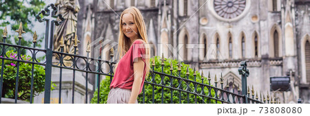 BANNER, LONG FORMAT Young woman tourist on background of St Joseph's Cathedral in Hanoi. Vietnam reopens after coronavirus quarantine COVID 19 73808080