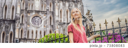 BANNER, LONG FORMAT Young woman tourist on background of St Joseph's Cathedral in Hanoi. Vietnam reopens after coronavirus quarantine COVID 19 73808083