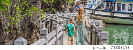 BANNER, LONG FORMAT Mom and son travelers in Halong Bay. Vietnam. Travel to Asia, happiness emotion, summer holiday concept. Picturesque sea landscape. Ha Long Bay, Vietnam. After coronavirus COVID 19 73808153