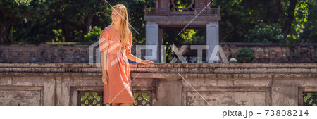 BANNER, LONG FORMAT Woman tourist in Temple of Literature in Hanoi in Southeast Asia, Vietnam. Temple of Confucius in Vietnamese capital. Vietnam reopens after coronavirus quarantine COVID 19 BANNER, LONG FORMAT Woman tourist in Temple of Literature in Hanoi in Southeast Asia, Vietnam. Temple of Confucius in Vietnamese capital. Vietnam reopens after coronavirus quarantine COVID 19 73808214