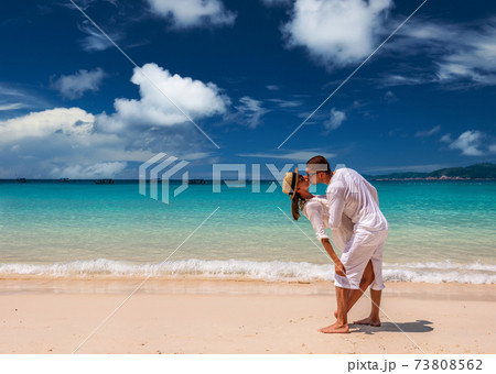 Couple in white having fun on a beach 73808562