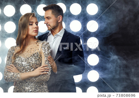 couple posing against the backdrop of spotlights couple posing against the backdrop of spotlights 73808696