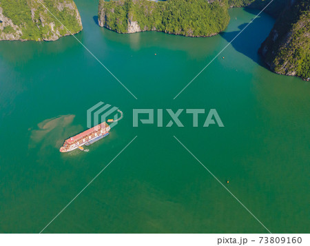 Aerial view panorama of floating fishing village and rock island, Halong Bay, Vietnam, Southeast Asia. UNESCO World Heritage Site. Junk boat cruise to Ha Long Bay. Popular landmark of Vietnam 73809160