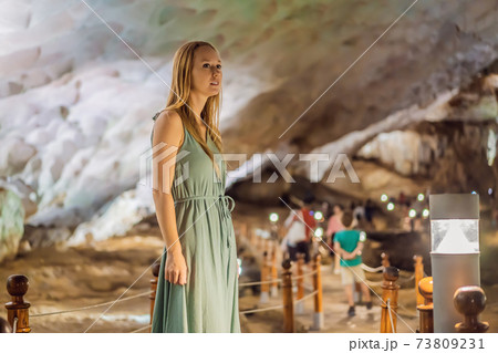 Woman tourist in Hang Sung Sot Grotto Cave of Surprises, Halong Bay, Vietnam Woman tourist in Hang Sung Sot Grotto Cave of Surprises, Halong Bay, Vietnam 73809231
