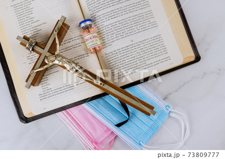 Negative attitude of the church to vaccination with Bible readings and prayer and covid-19 vaccine bottle Negative attitude of the church to vaccination with Bible readings and prayer and covid-19 vaccine bottle 73809777