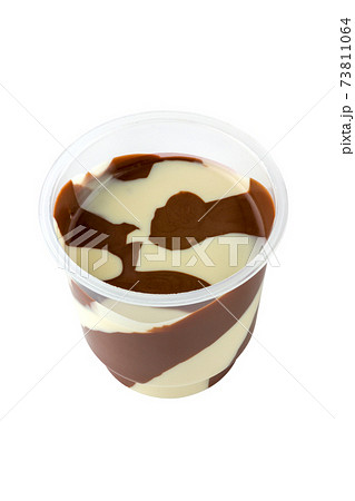 Chocolate paste in a plastic jar. Chocolate - milk paste in a plastic container on a white background. 73811064