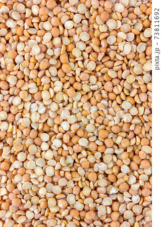 Pile of chipped peas close-up. Dry peas yellow, top view. 73811692
