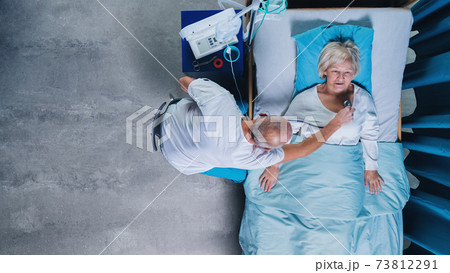 Top view of doctor with stethoscope examining patient in bed in hospital. Copy space. Top view of doctor with stethoscope examining patient in bed in hospital. Copy space. 73812291