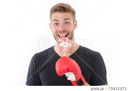 I deserve this. Sportsman boxing glove holds lollipop. I deserve this. Sportsman boxing glove holds lollipop. 73812371