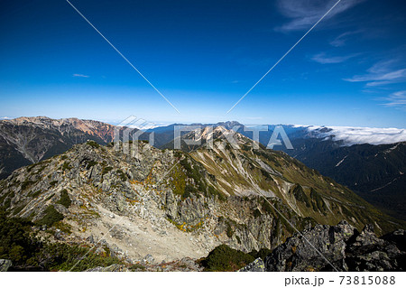 北アルプス 水晶岳山頂から赤牛岳と薬師岳と立山連峰の写真素材